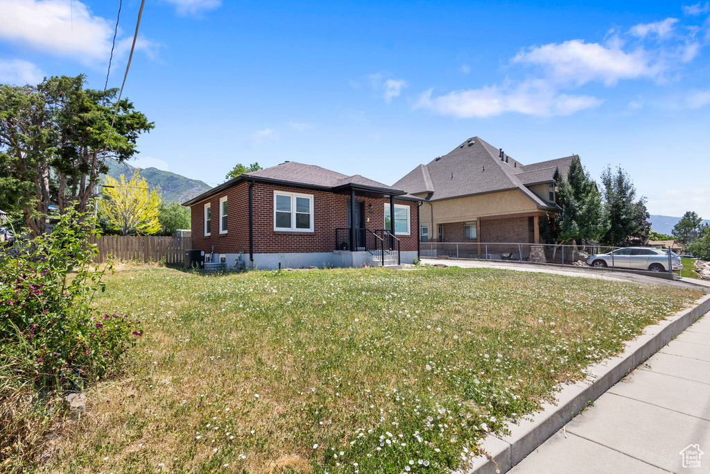 View of front of home featuring brick siding and a mountain view