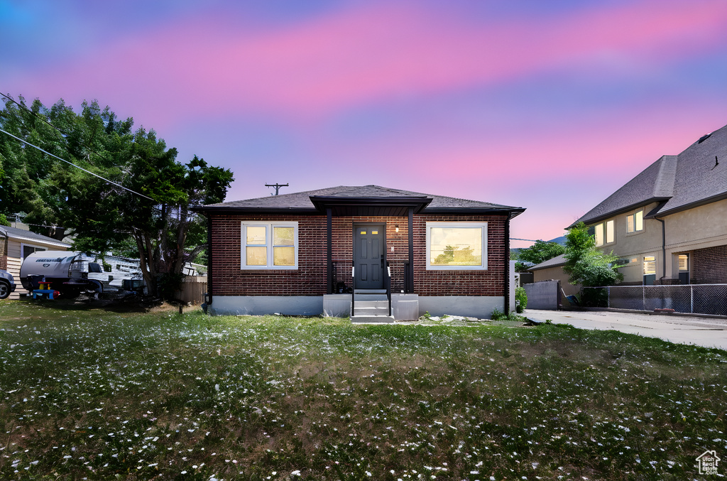Bungalow-style house featuring brick siding and entry steps