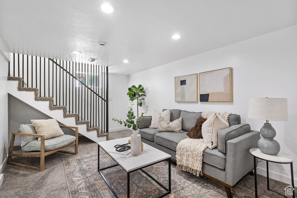 Living room featuring stairway and recessed lighting