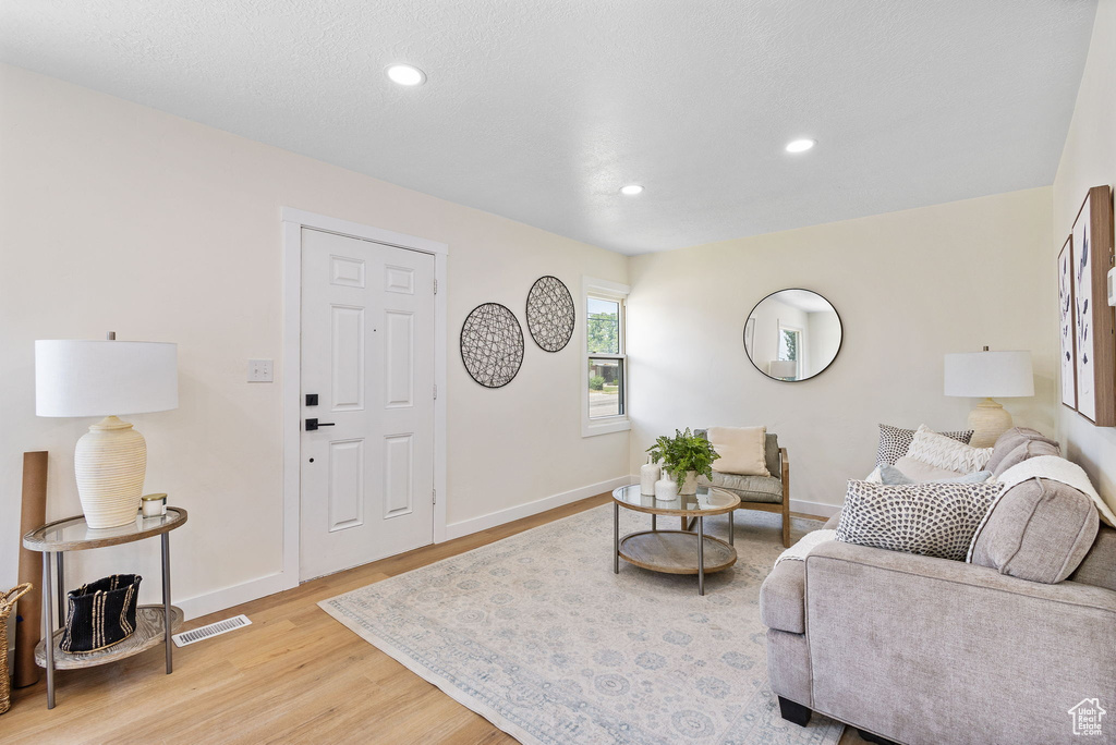 Living room featuring light wood-style floors and recessed lighting