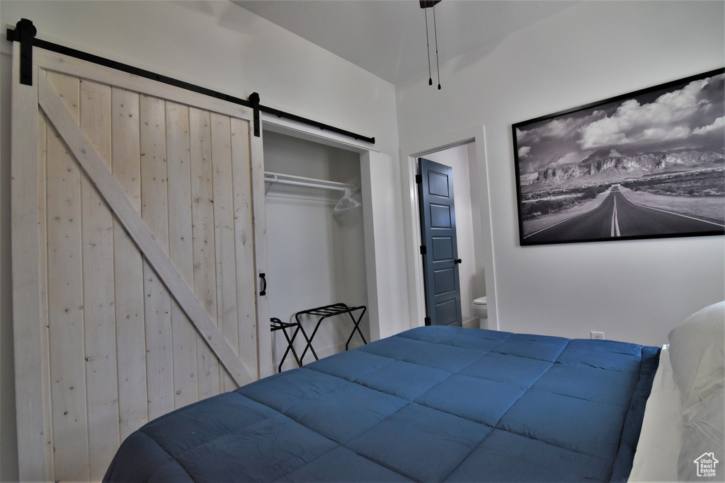 Bedroom with a barn door and a closet