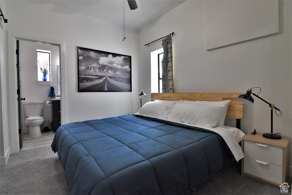 Bedroom featuring ensuite bath and ceiling fan