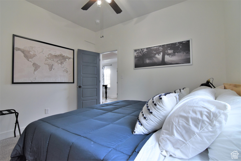 Carpeted bedroom featuring ceiling fan