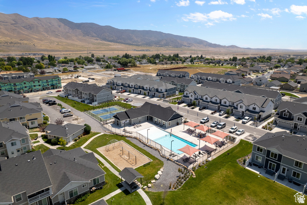Aerial perspective of suburban area with a pool area and a mountain backdrop
