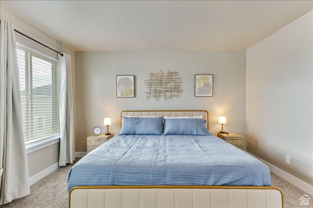 Carpeted bedroom featuring baseboards