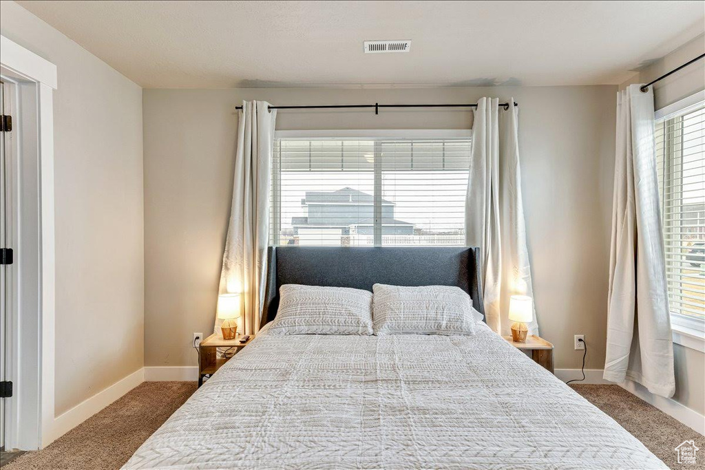 Carpeted bedroom featuring baseboards