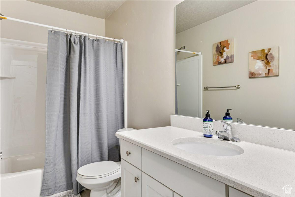 Full bathroom with vanity, toilet, and shower / bath combo