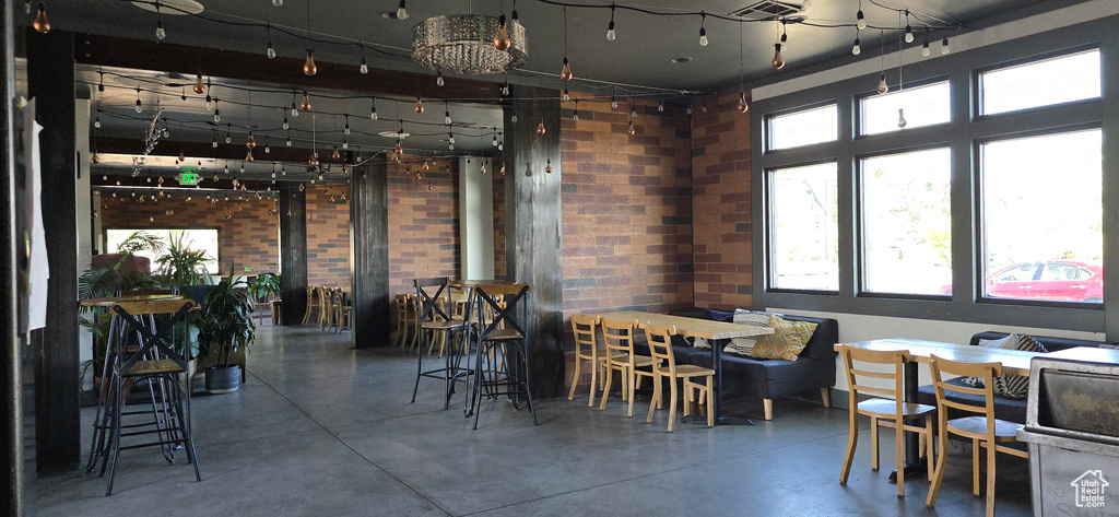 Dining room with concrete floors and brick wall
