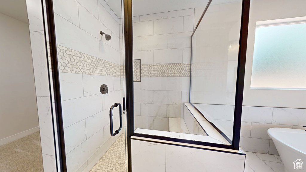 Bathroom featuring a stall shower and a soaking tub