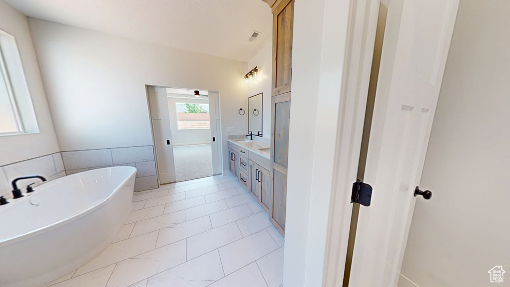 Bathroom featuring a soaking tub and double vanity