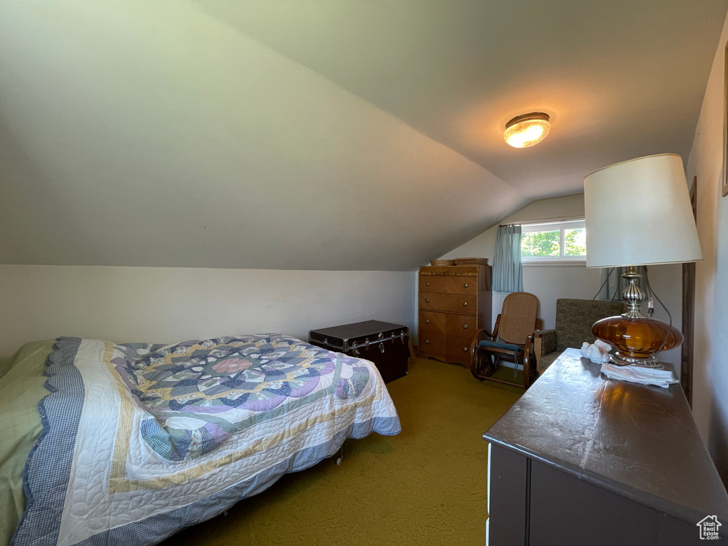 Carpeted bedroom with vaulted ceiling