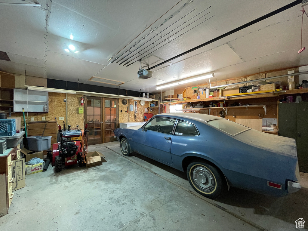 Garage featuring french doors and a garage door opener