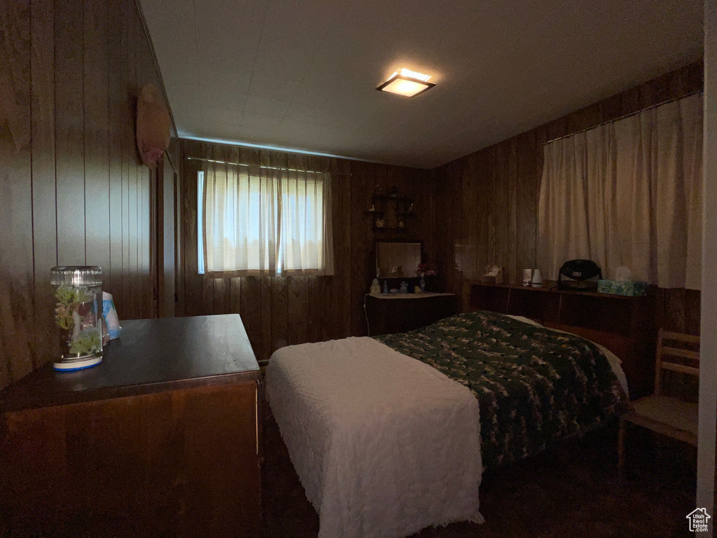 Bedroom with wood walls