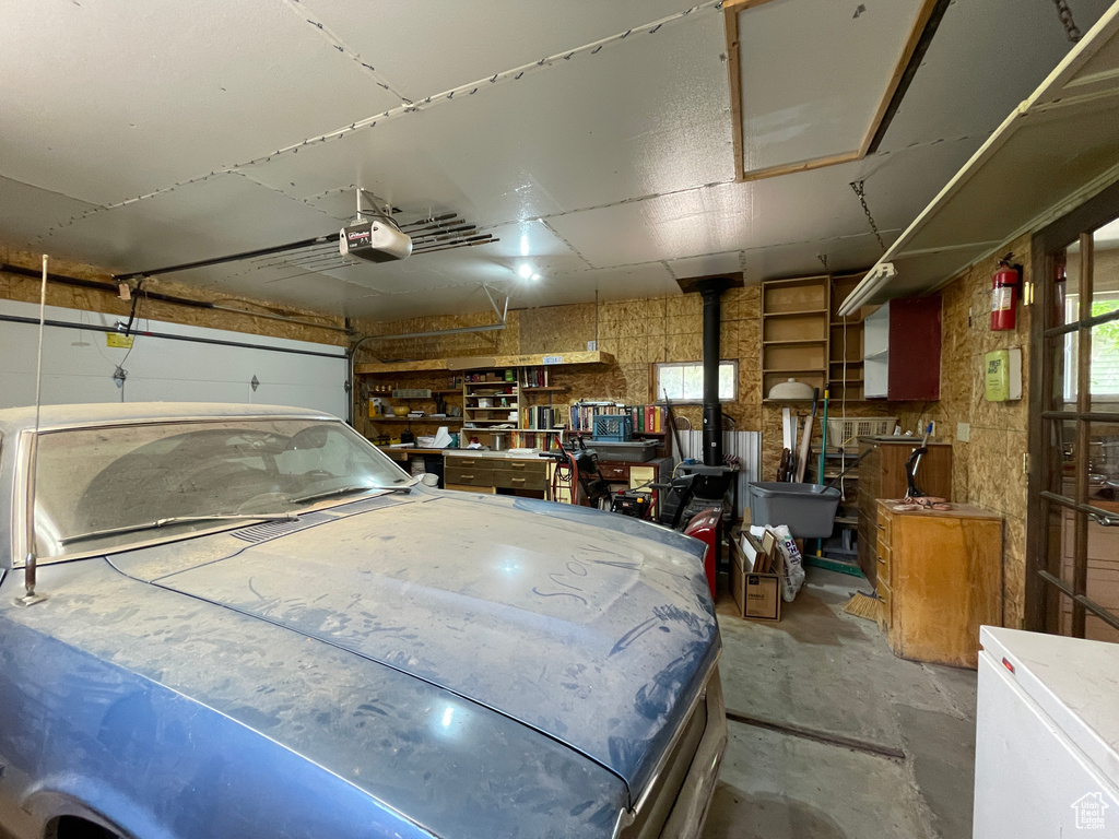 Garage with a garage door opener and fridge