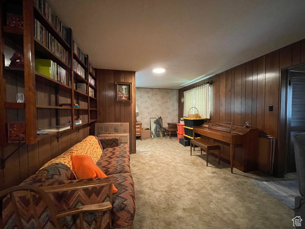 Living area with carpet and wooden walls