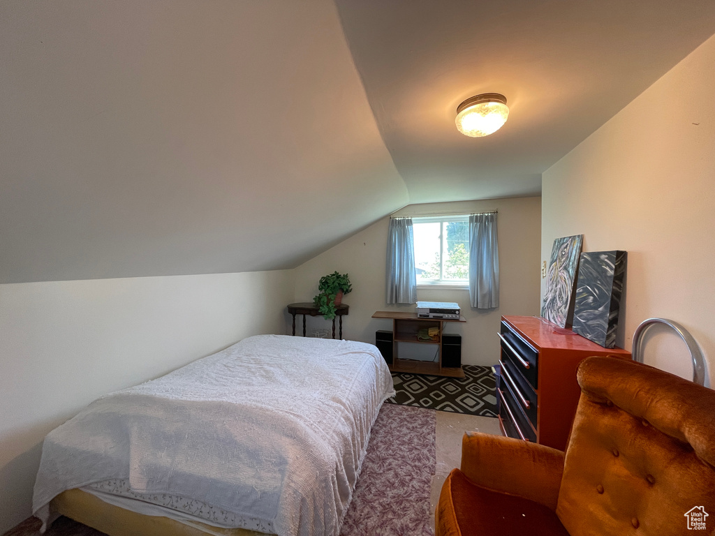 Carpeted bedroom with lofted ceiling