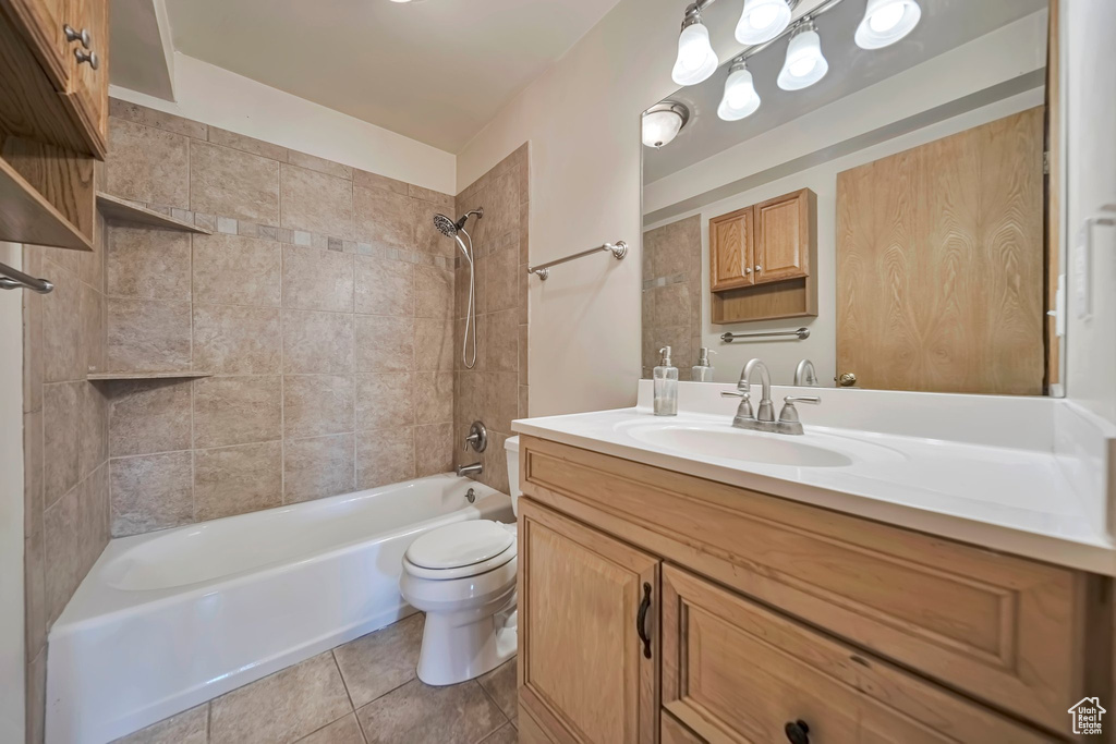 Full bathroom with vanity, toilet, shower / washtub combination, and tile patterned floors