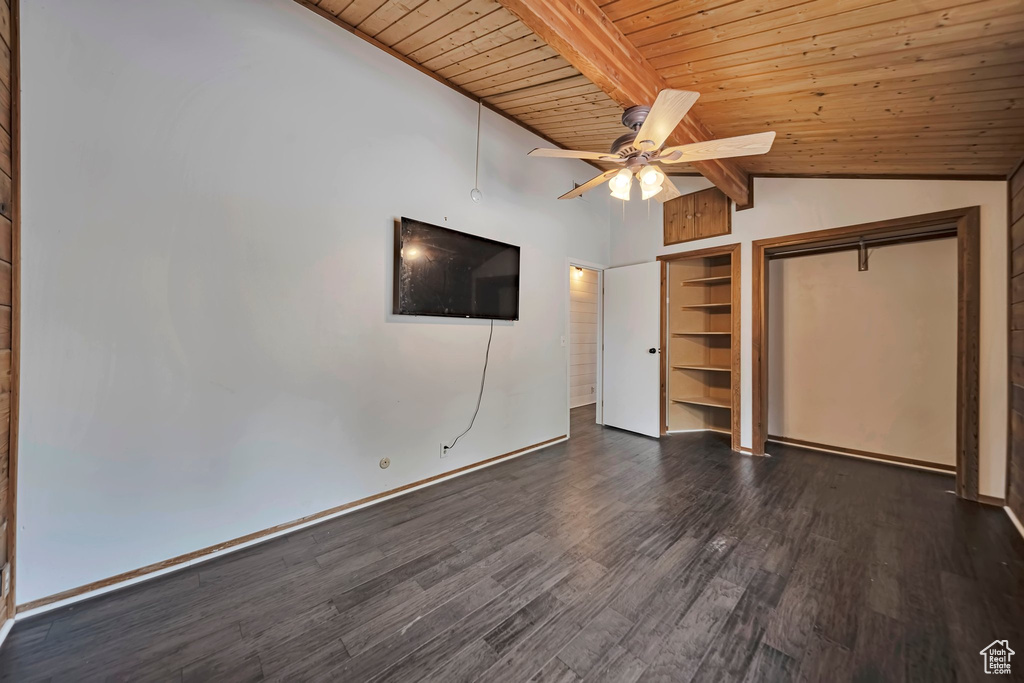 Unfurnished bedroom with dark wood-style floors, wood ceiling, ceiling fan, a closet, and baseboards