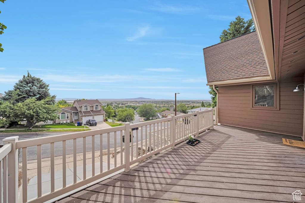 Wooden terrace with a residential view and a mountain view