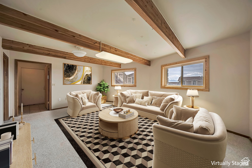 Living area with carpet, baseboards, and beam ceiling