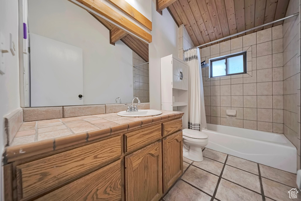 Bathroom featuring vanity, tile patterned flooring, toilet, shower / bath combination with curtain, and wood ceiling