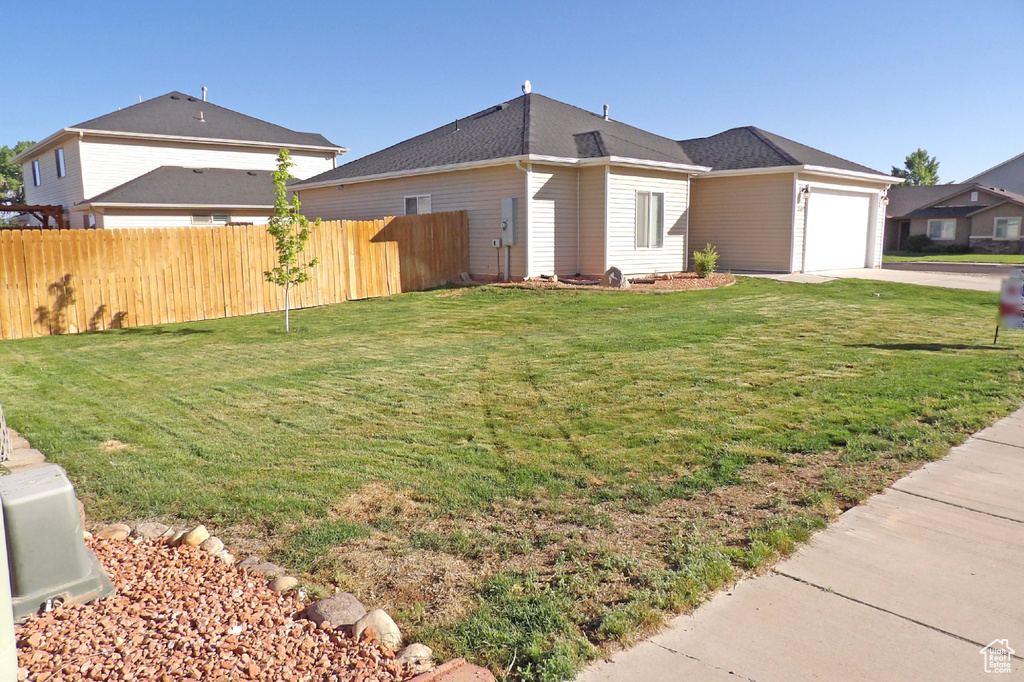 View of home's exterior featuring driveway, a garage, and roof with shingles