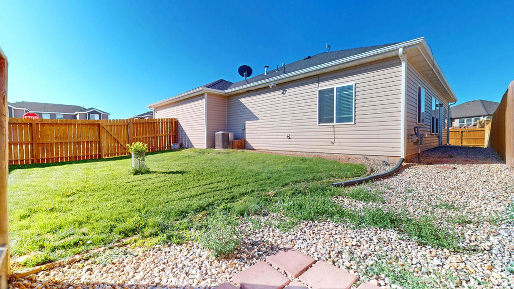 Rear view of property featuring central AC unit