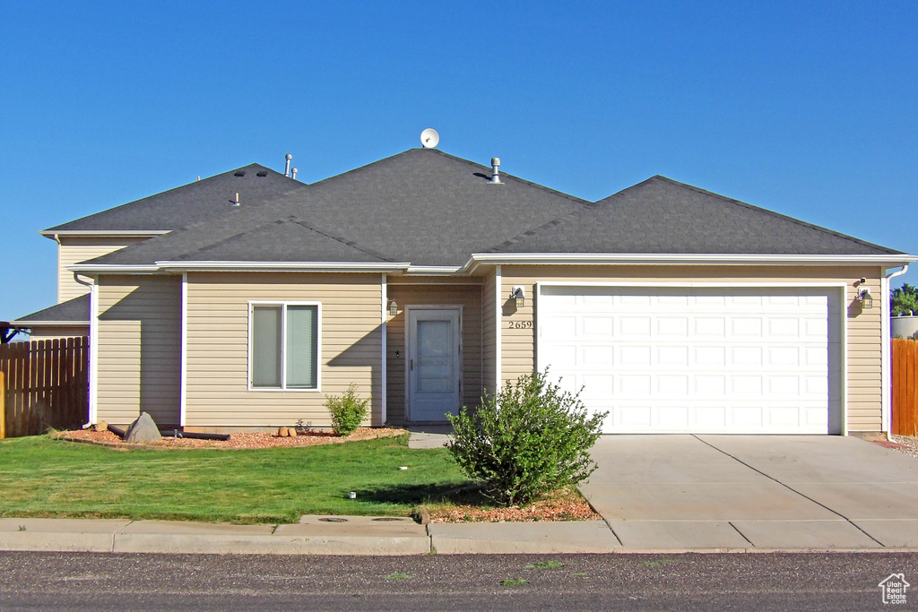 Single story home featuring driveway, a garage, and a shingled roof