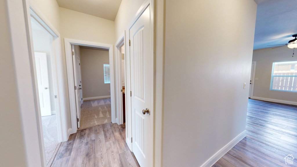 Hall featuring light wood-type flooring and baseboards