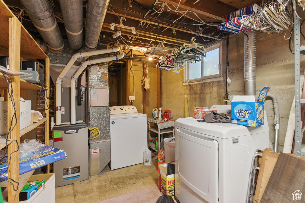 Basement with washing machine and clothes dryer and heating unit