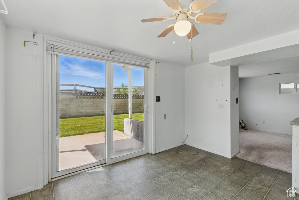 Empty room featuring plenty of natural light and a ceiling fan