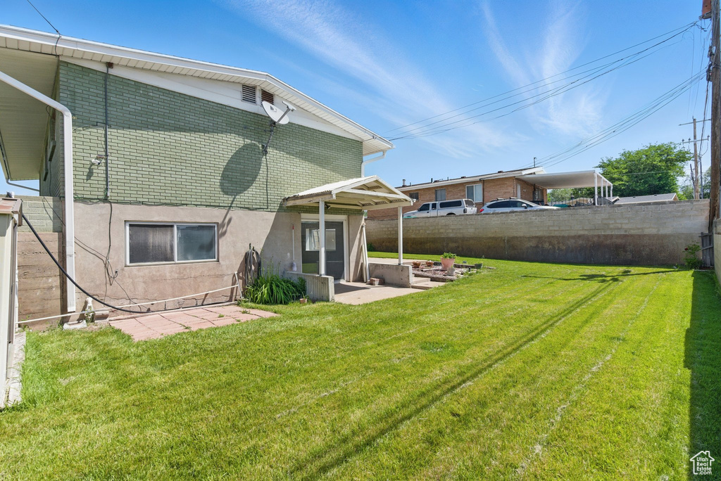 Rear view of house featuring a patio area and brick siding