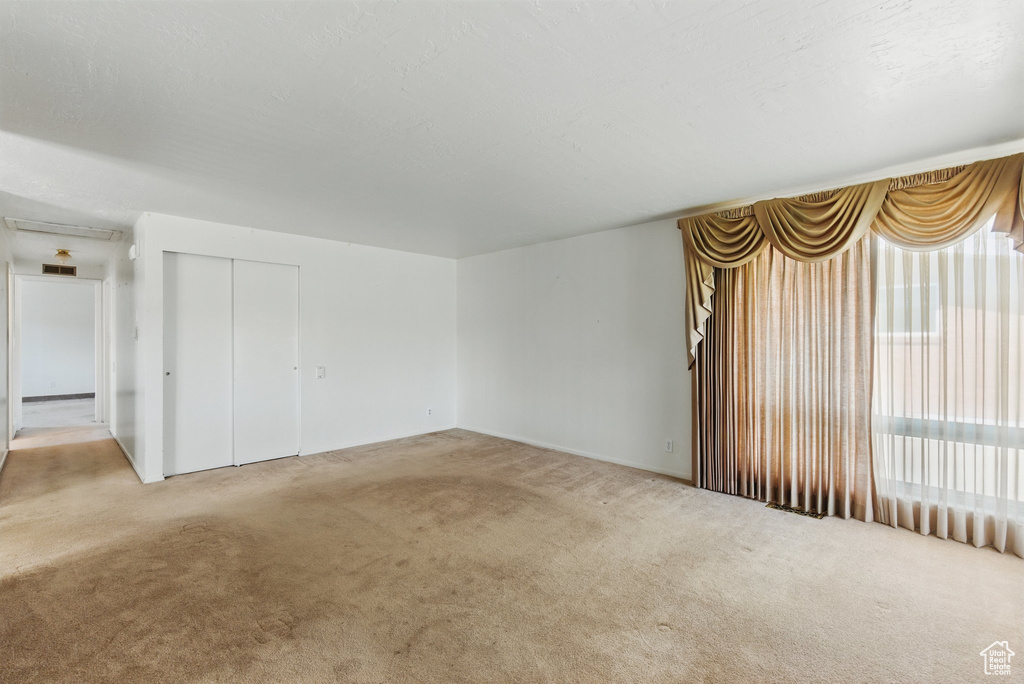 Unfurnished living room featuring carpet flooring