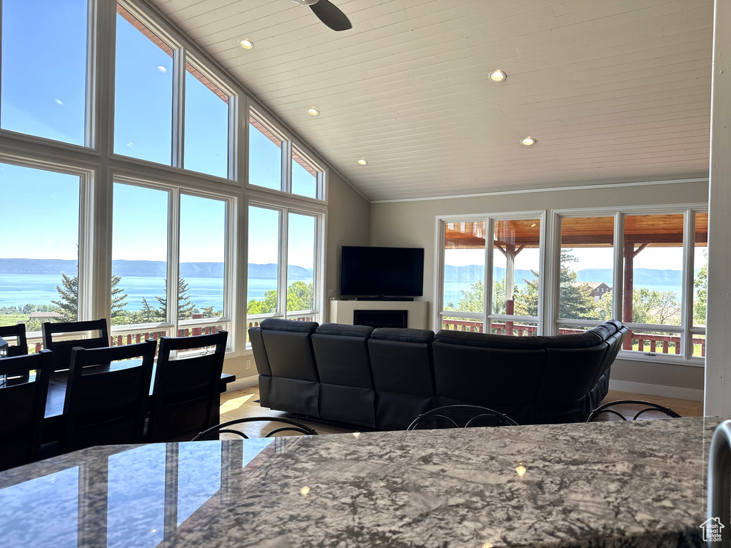 Living room with recessed lighting, baseboards, a water view, wooden ceiling, and high vaulted ceiling