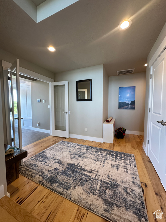 Entryway with baseboards, light wood-style floors, and recessed lighting