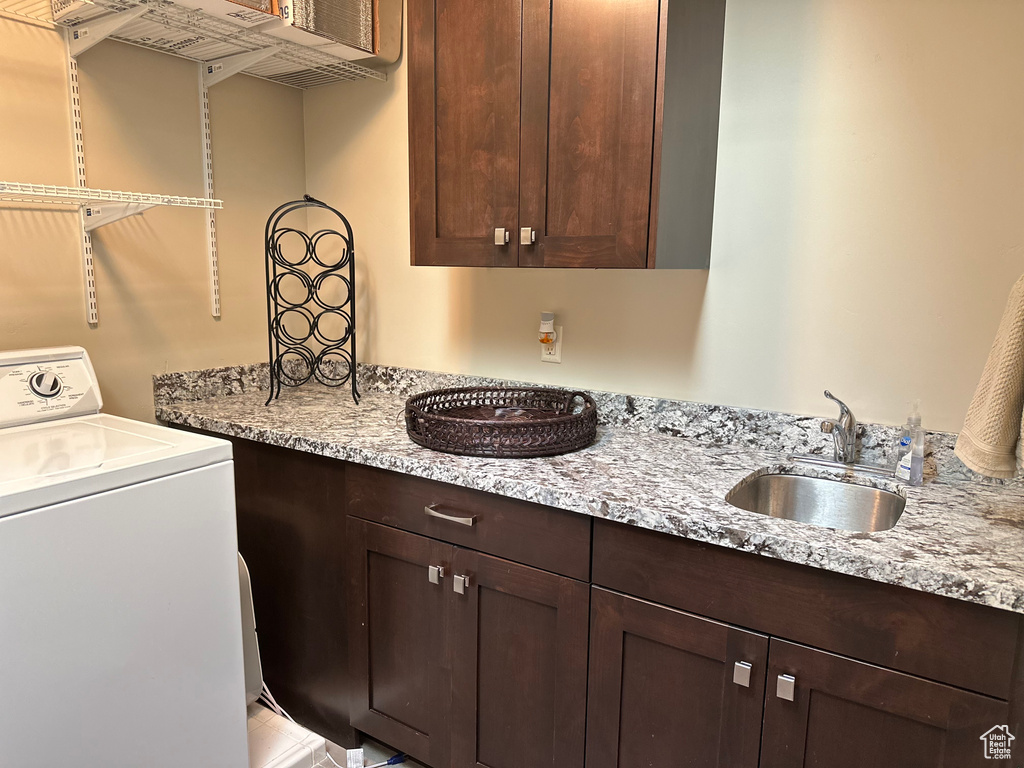 Washroom with washer / clothes dryer and a sink