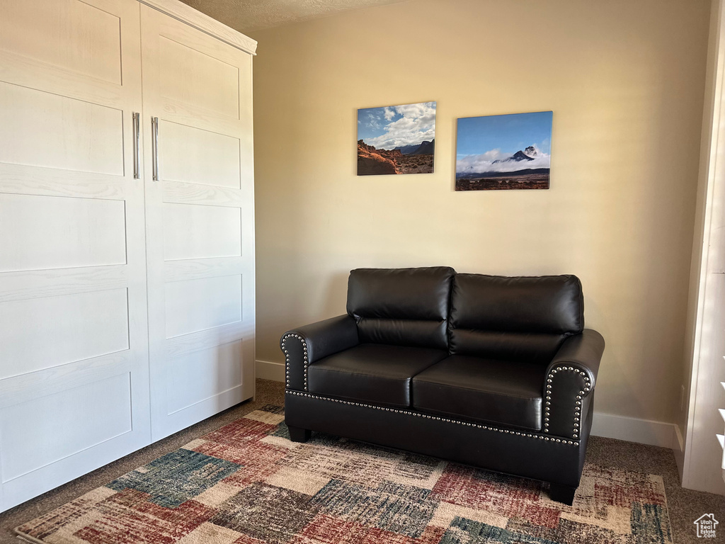 Living area with baseboards and carpet flooring