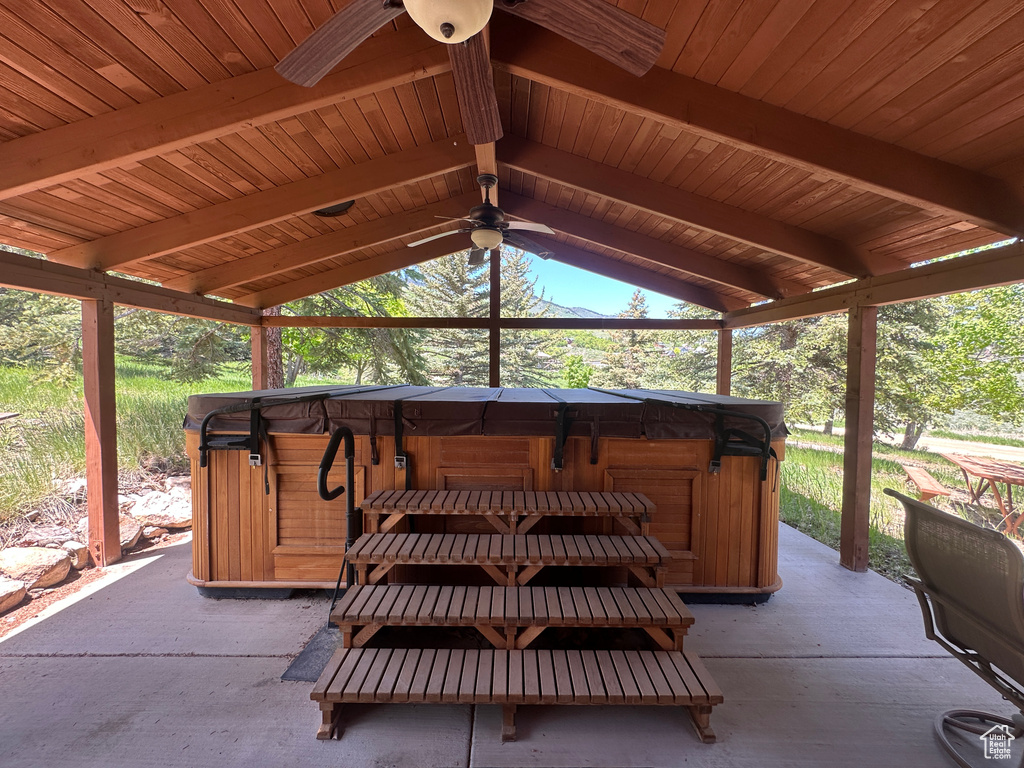 View of patio featuring a hot tub and a gazebo