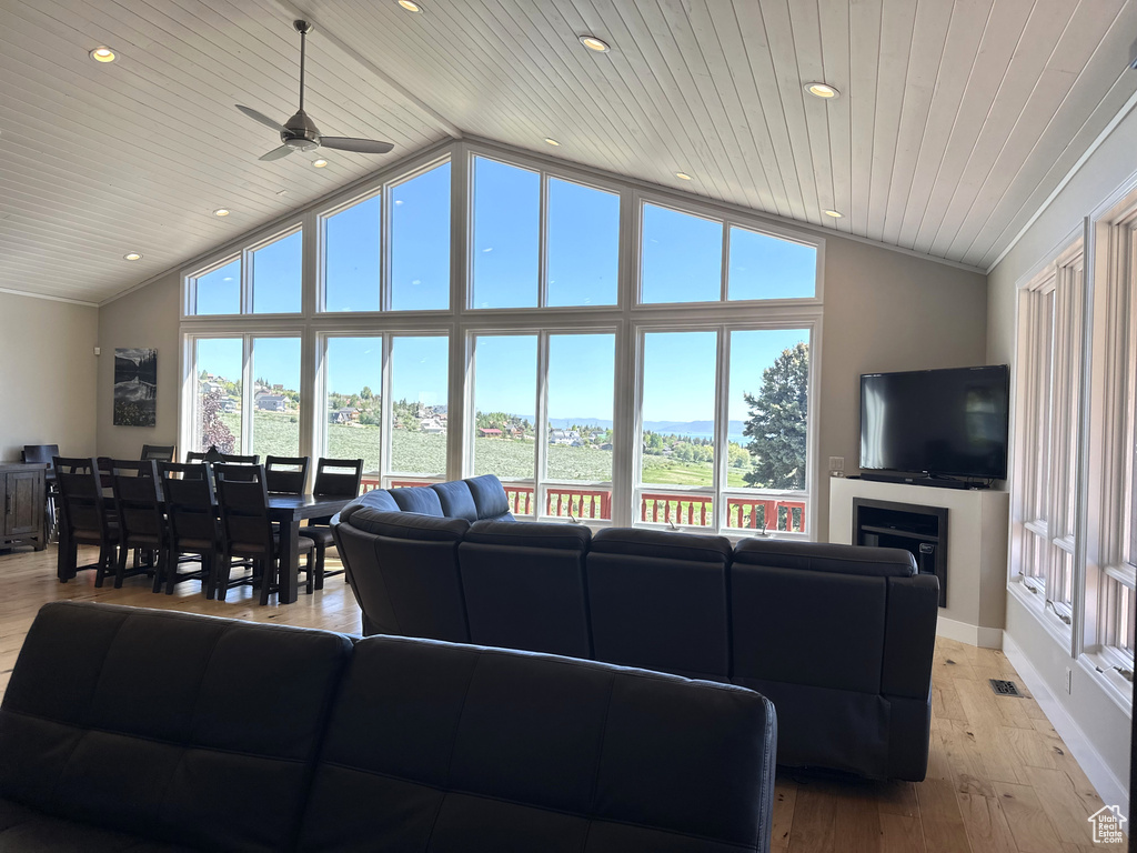 Living room featuring plenty of natural light, wood ceiling, ceiling fan, recessed lighting, and light wood-style flooring