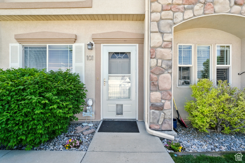 Property entrance with stucco siding and stone siding