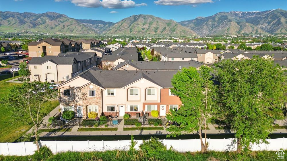Aerial view of residential area featuring a mountainous background