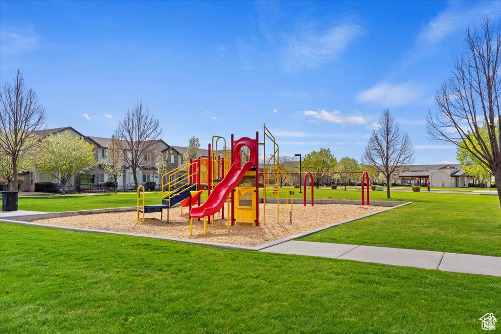 Community jungle gym featuring a yard and a residential view