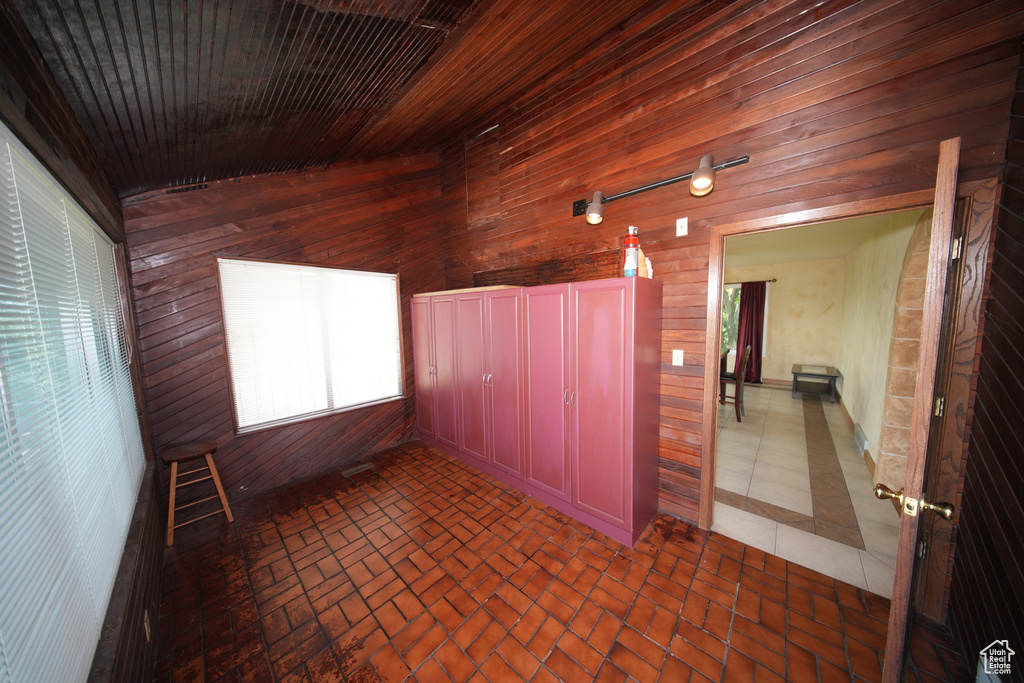Unfurnished sunroom featuring vaulted ceiling