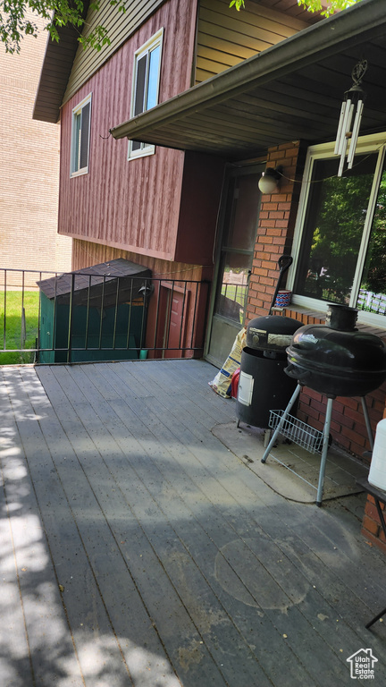 View of patio with a grill
