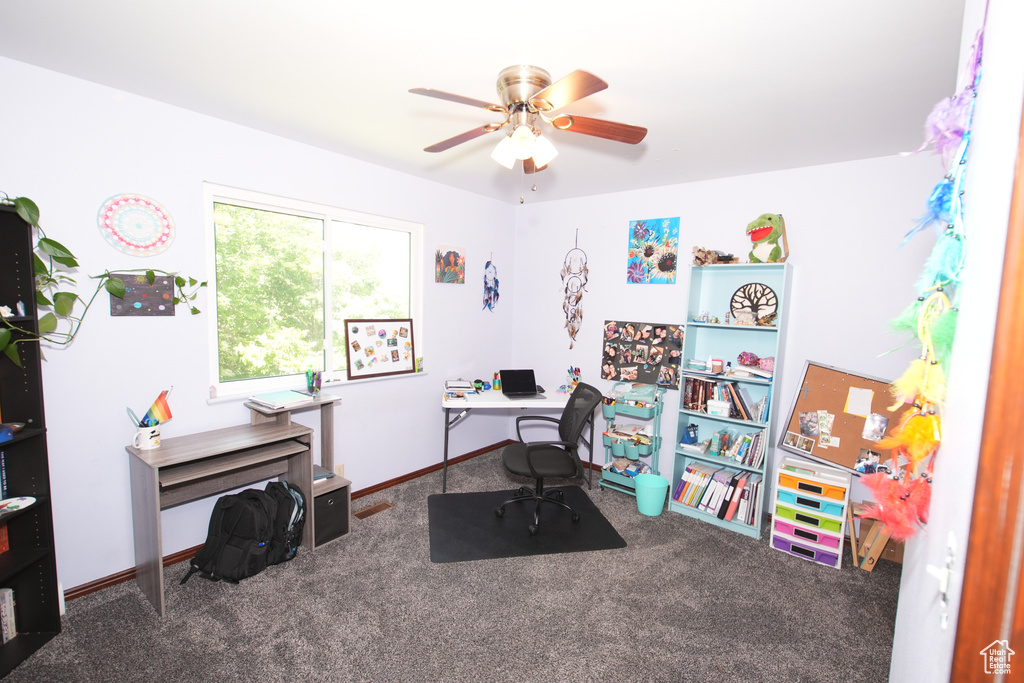 Office with carpet flooring and a ceiling fan