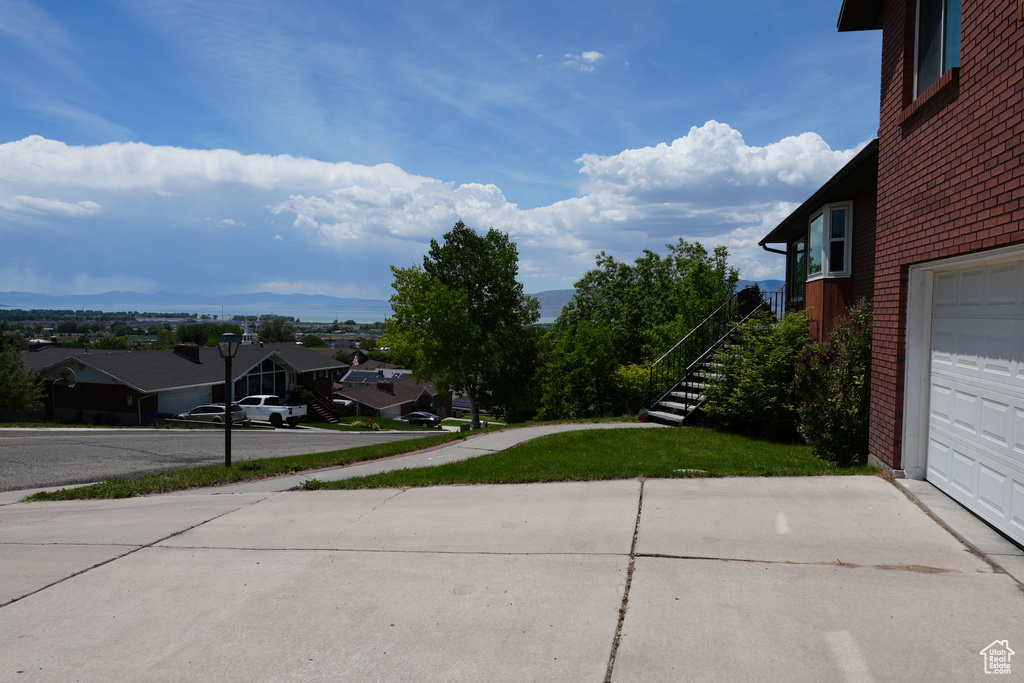 View of yard with a residential view and stairs