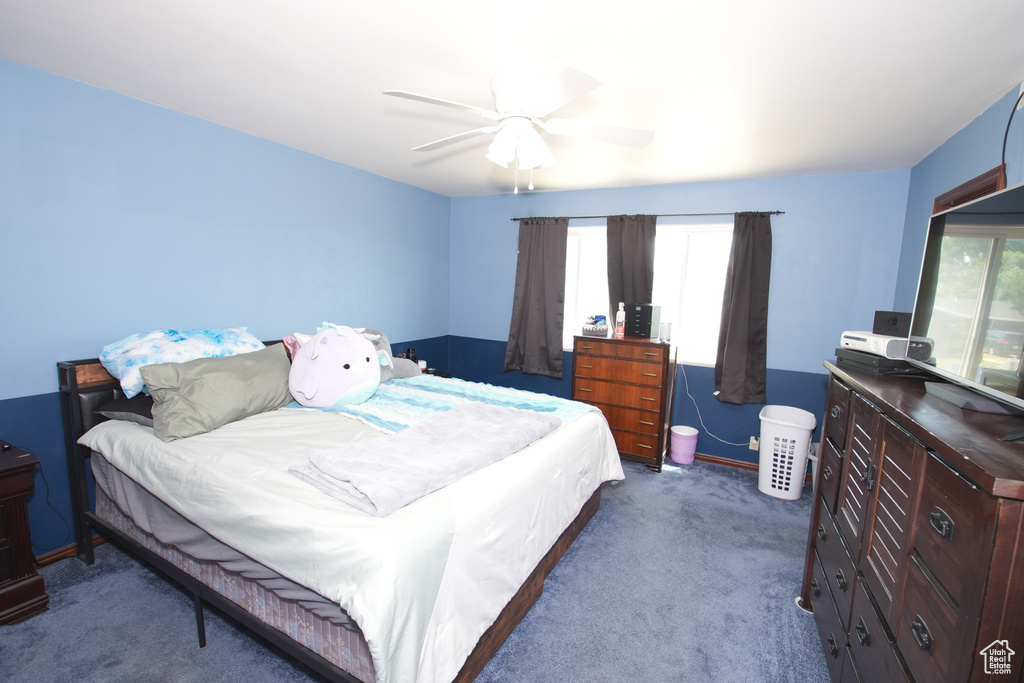 Bedroom featuring dark colored carpet and a ceiling fan