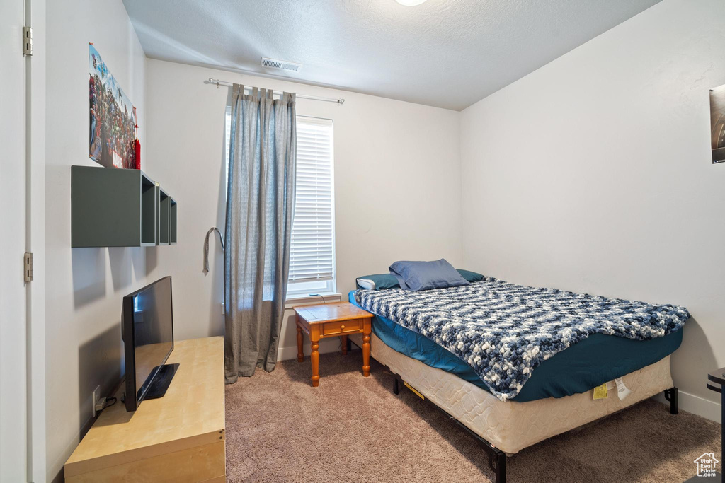 Carpeted bedroom featuring baseboards