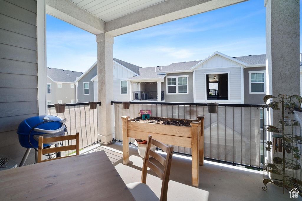 View of patio with a balcony and a grill