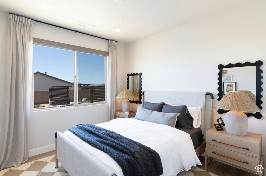 Bedroom featuring wood finished floors, baseboards, and recessed lighting